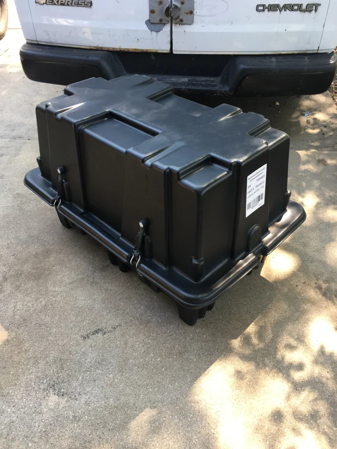 Closed transmission transport case beside an AMPro delivery vehicle